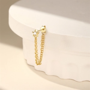 Detail of S925 sterling silver star stud with double gold chains and sparkling zircon