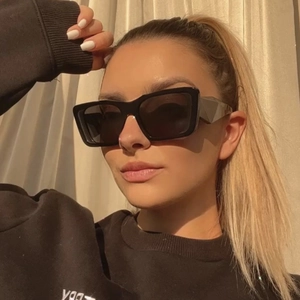 Close-up of retro black square cat eye sunglasses with thick frame on a female model