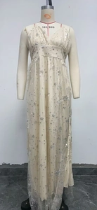 Detailed view of beige maxi dress with V-neck straps and silver star sequin patterns