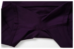 Macro view of high-elasticity purple yoga wear with reinforced flatlock stitching detail