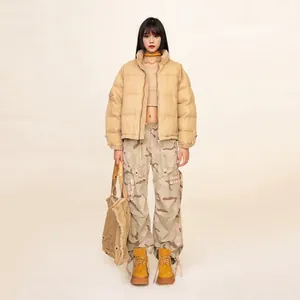Streetwear outfit with beige explorer puffer jacket, camo cargo pants, and yellow boots