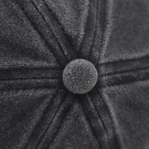Macro shot of dark grey washed cotton baseball cap crown with stitched panels and top button