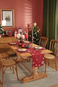 Detail of red Christmas table runner and placemats with snowflake and ornament patterns