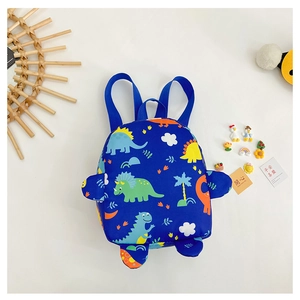 Detail of blue toddler backpack with cartoon dinosaur prints and 3D decorative parts