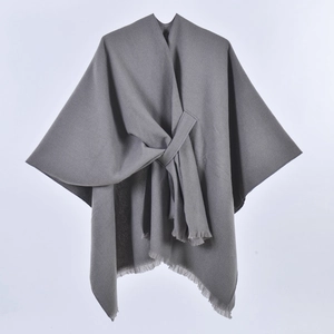 Detailed view of gray cashmere-like shawl featuring lace-up knot and fringe tassels