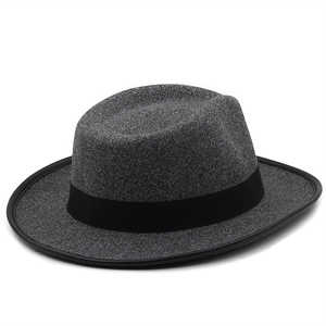 Close-up of gray wool fedora hat featuring black ribbed band and reinforced stitched edges