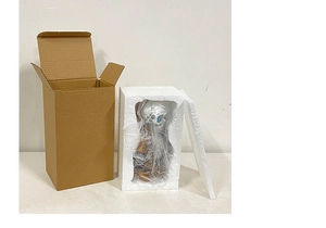 Detail view of owl skeleton decoration with foam lining and corrugated cardboard packaging