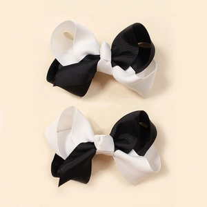 Close-up of black and white grosgrain ribbon hair bows for babies in a pair