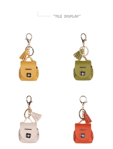 Detailed tile display of mini leather backpack keychains in four vibrant colors