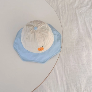 Detail of embroidered fruit motif on a quick-dry sun hat for children with petal brim
