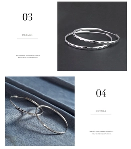 Macro detail of silver hoop earrings featuring a geometric diamond-cut textured surface