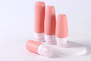 Set of 4 pink silicone travel bottles with 100ml and 60ml capacity markers and white caps