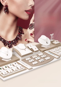Macro detail of white and beige leather jewelry display stands for necklaces and rings