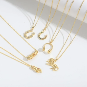 Detailed close-up of golden lion, horseshoe, and headphone charms on vintage necklaces