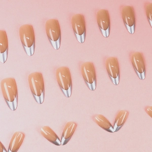 Minimalist French nude pink press-on nails with shiny silver metallic almond tips