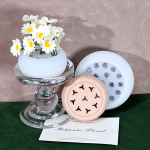 Detailed view of pink and white spiral silicone flower stem holders with daisies