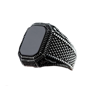 Detailed view of vintage men's ring with square black agate inlay and engraved metal band