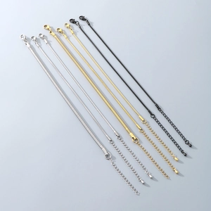 Detail of adjustable snake chain bracelets in silver, gold and black with lobster clasps