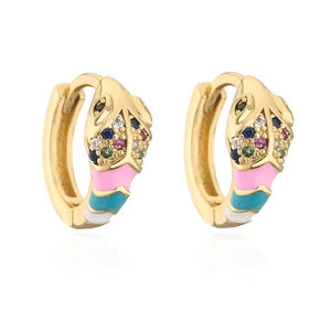 Macro detail of snake-shaped earrings with colorful zircons and enamel finish on gold plating