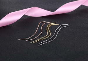 Three minimalist long tassel threader earrings in rose gold, gold, and silver on silk ribbon