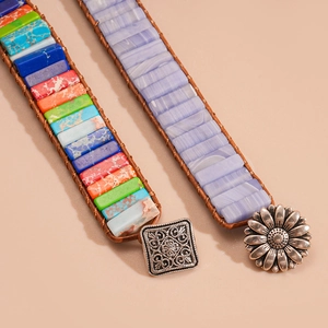 Detail of bohemian braided leather bracelets with colorful natural stones and metal clasps