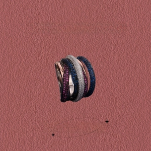 Detailed close-up of multi-layer crisscross ring with blue and purple micro-pave stones