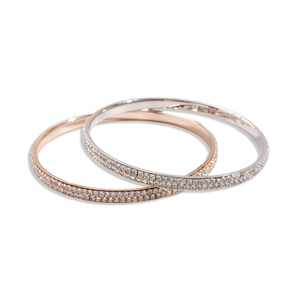 Minimalist silver and rose gold bangles with paved rhinestones on white background
