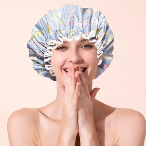 Detail of light blue waterproof shower cap with cute rabbit pattern and elastic band