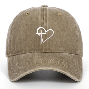 Detail of embroidered heart and cross on washed cotton khaki baseball cap