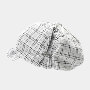 Detail of classic black and white plaid deerstalker hat with silver S-shaped metal hook