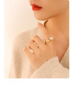 Macro detail of 18K gold-plated ring featuring an elegant rectangular white shell inlay