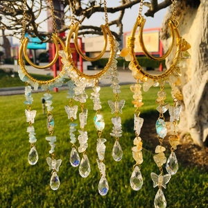 Detailed outdoor shot of suncatchers with natural crystal chips and teardrop prisms