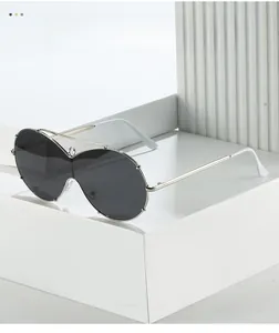 Close-up of oversized shield sunglasses with silver metal frame and dark grey lenses