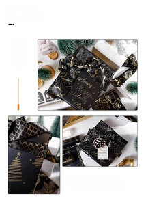Detail of luxury black and gold Christmas gift wrapping paper with ribbons and cards