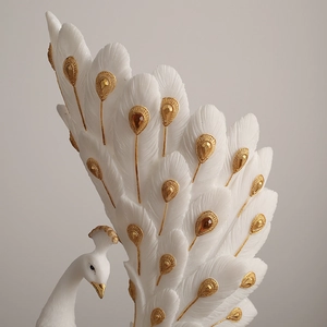 Elegant white peacock flower vase with gold feather detailing and amber resin accents