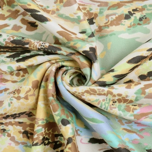Detail of colorful abstract camo print fabric with elegant spiral drape and silky texture