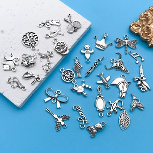 Detailed close-up of antique silver alloy charms including princess and animal motifs