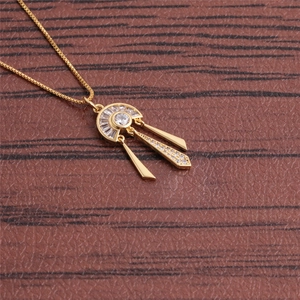 Golden fan-shaped fringe necklace with micro-pave zircons on a leather background