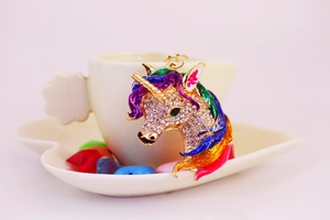 Macro view of crystal unicorn keychain with rainbow enamel mane and sparkling rhinestones
