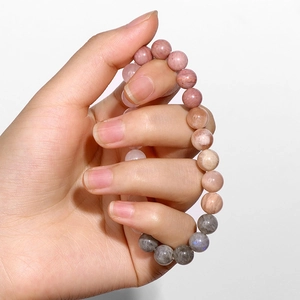 Close-up of 8mm natural moonstone and sunstone beads on a stretch bracelet