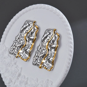 Irregular wavy textured stainless steel stud earrings with silver and gold color contrast