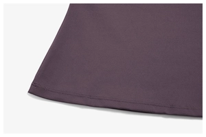Detailed close-up of double-stitched hem on dark purple yoga set with high-end fabric texture