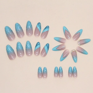 Almond blue glitter gradient press-on nails with French tips and rhinestone accents