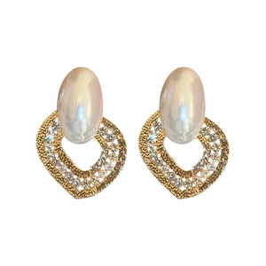 Elegant gold heart earrings with faux pearls and sparkling crystals on white background