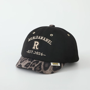 Detail of kids baseball cap featuring leopard print brim and 3D letter embroidery