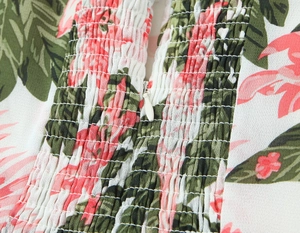 Détail du tissu froncé à fleurs tropicales et fermeture éclair invisible sur la robe