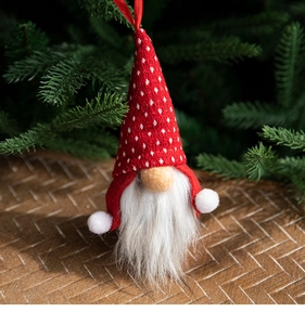 Close-up of a Swedish Tomte gnome hanging ornament with red knitted hat and white faux beard