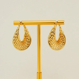 Textured gold braided hoop earrings on a T-stand minimalist display for women