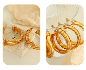 Macro shot of gold hoop earrings with twisted spiral texture and pavé crystal rhinestones