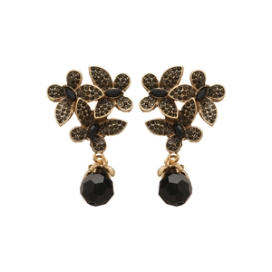 Vintage bronze flower earrings with black crystals and teardrop pendants on white backdrop